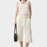 Cream flecked knit tank top worn with matching skirt and sandals