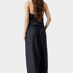 Black maxi pants with elastic waistband and relaxed wide leg silhouette, worn with matching top