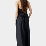 Black maxi pants with elastic waistband and relaxed wide leg silhouette, worn with matching top