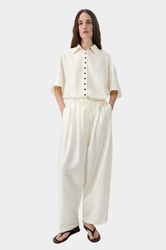 Marfil cream wide leg pants with elastic waist and soft drape, worn with matching short sleeve shirt