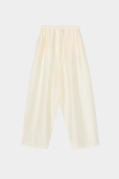 Cream maxi pants with elastic waistband, drawstring closure, and wide leg silhouette