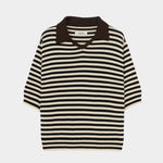 Cordera organic cotton V-neck polo in black and cream stripe, flat lay highlighting boxy silhouette, ribbed hem, and short sleeves