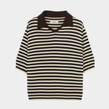 Cordera organic cotton V-neck polo in black and cream stripe, flat lay highlighting boxy silhouette, ribbed hem, and short sleeves