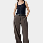 Navy ribbed button-front tank top worn with wide leg trousers and belt, relaxed structured styling