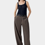 Navy ribbed button-front tank top worn with wide leg trousers and belt, relaxed structured styling