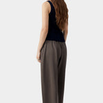 Navy ribbed knit tank top with fitted silhouette and clean back, worn with tailored trousers