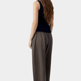 Navy ribbed knit tank top with fitted silhouette and clean back, worn with tailored trousers