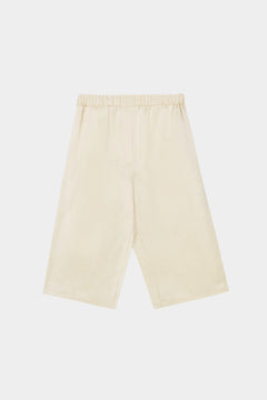Cordera satin capri pants in marfil, flat lay showing clean waistband, wide-leg shape, and smooth satin finish