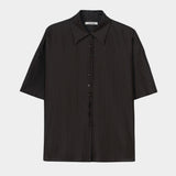Black short sleeve button-up shirt with pointed collar, boxy silhouette, and lightweight textured fabric