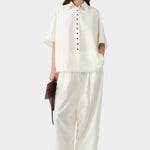 Marfil cream short sleeve shirt with relaxed fit and button front, worn with matching wide leg pants