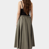 Vetiver green midi skirt in lightweight cotton with full silhouette and elastic waistband, worn from back