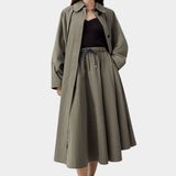 Vetiver green cotton technical midi skirt with elastic waist and drawstring, worn with black ribbed tank and sandals