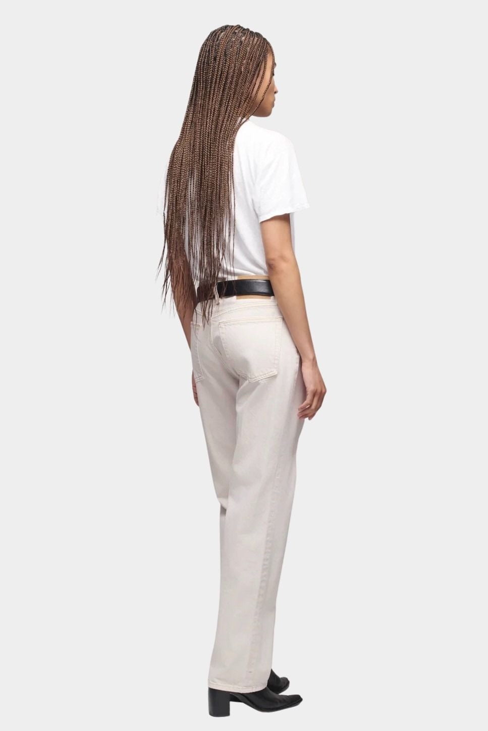 DALA Calla mid rise straight ankle jeans in salt, back view on model with black belt and boots