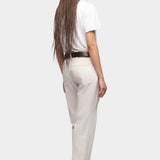 DALA Calla mid rise straight ankle jeans in salt, back view on model with black belt and boots