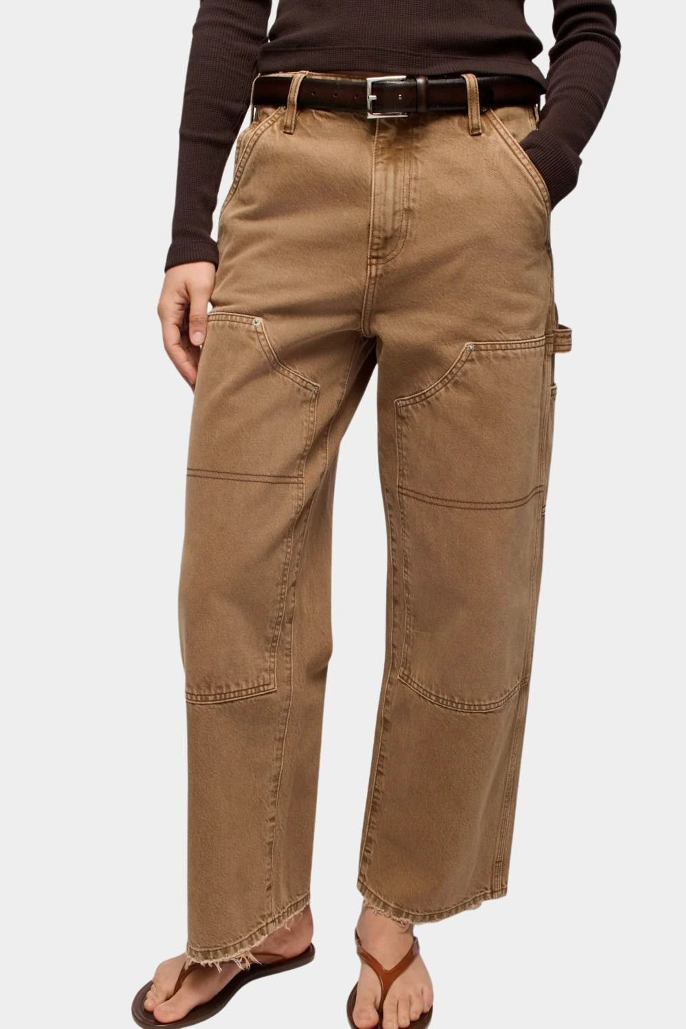 DALA Dove Carpenter Jeans in Oak Brown, close front view showing angled pockets, carpenter panels and frayed hems.