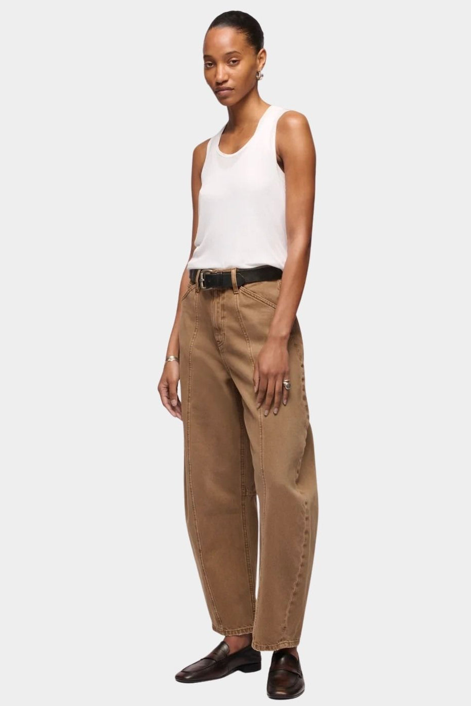DALA Lido Ankle Jean in Oak Brown, angled front view showing the mid rise waist and curved leg silhouette.