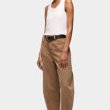 DALA Lido Ankle Jean in Oak Brown, angled front view showing the mid rise waist and curved leg silhouette.