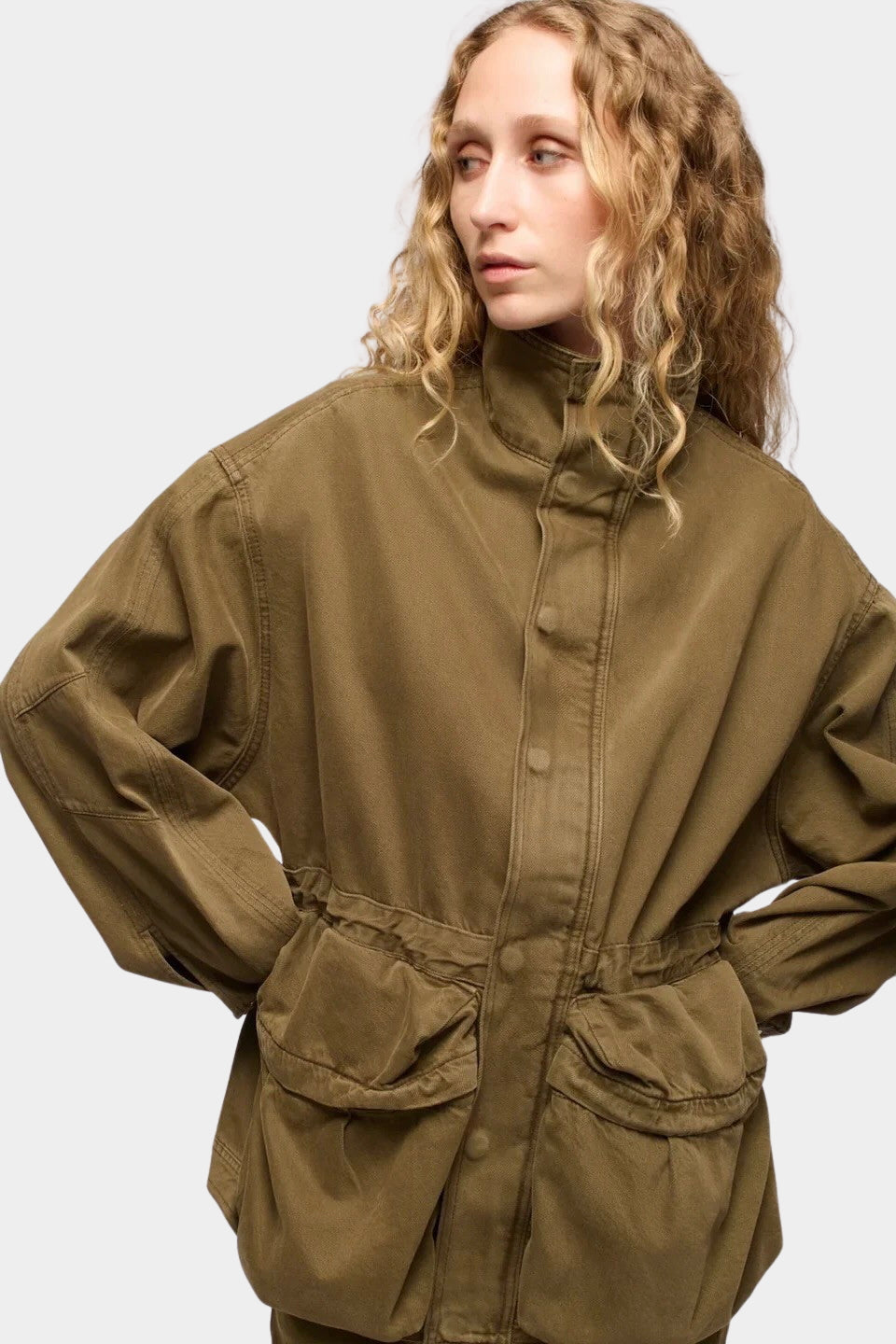 DALA Mountain Jacket Dark Olive detail with high collar, toggle waist and utility pockets at YUCCA Denver