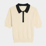 DEMYLEE Celia waffle pointelle cotton short sleeve polo top in ecru with black contrast collar laid flat
