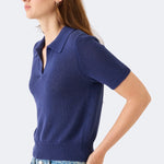 Model wearing DEMYLEE Cris indigo cotton linen knit polo top with slim fit and ribbed trim