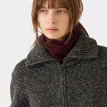 DEMYLEE Nessa Small Cashmere Scarf Garnet wrapped around the neck with a charcoal knit jacket