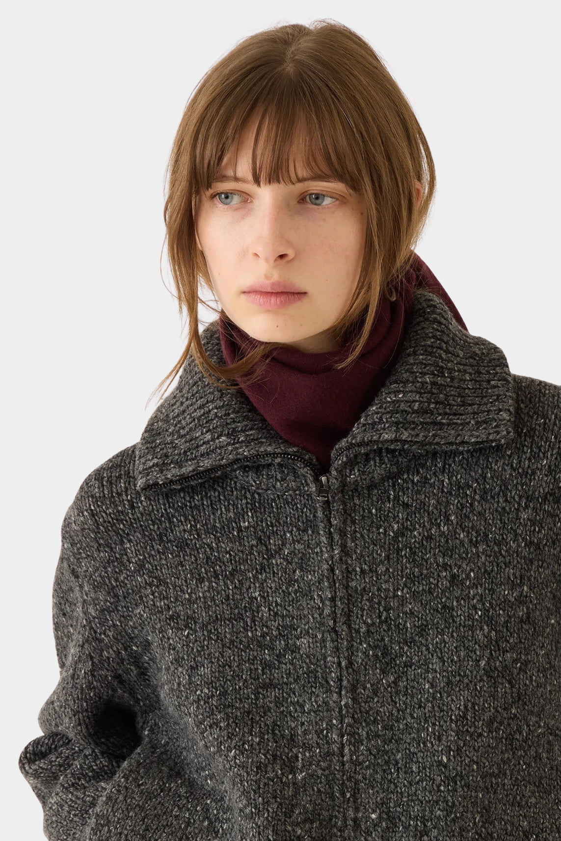 DEMYLEE Nessa Small Cashmere Scarf Garnet wrapped around the neck with a charcoal knit jacket