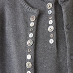 Front view of the charcoal DEMYLEE Soleil cotton cardigan with varied shell buttons