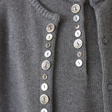 Front view of the charcoal DEMYLEE Soleil cotton cardigan with varied shell buttons