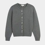 Close view of decorative shell buttons on the charcoal cardigan at YUCCA, a Denver women’s boutique