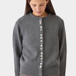 Model layering the charcoal DEMYLEE Soleil cotton cardigan over a coordinating knit top