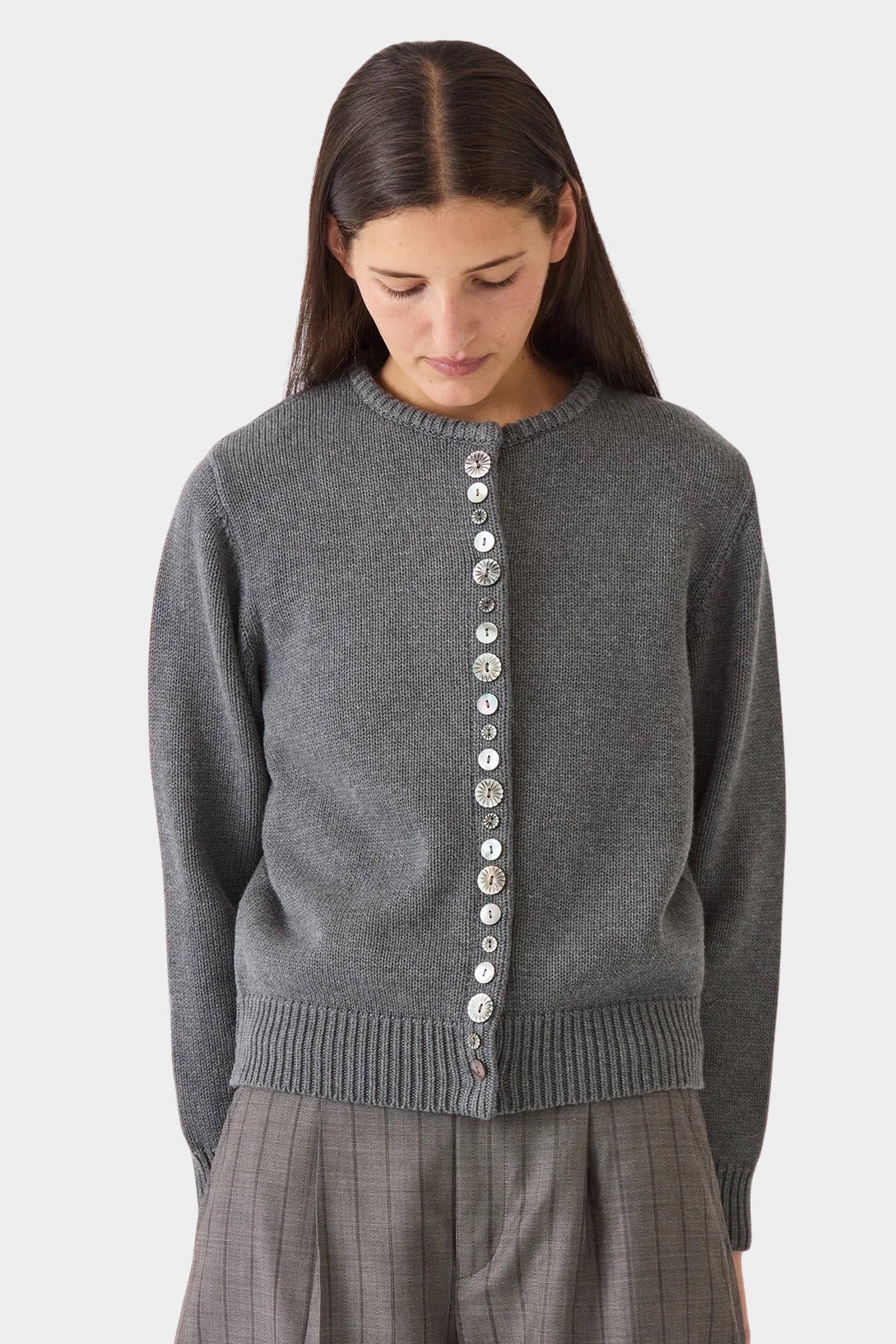 Model layering the charcoal DEMYLEE Soleil cotton cardigan over a coordinating knit top