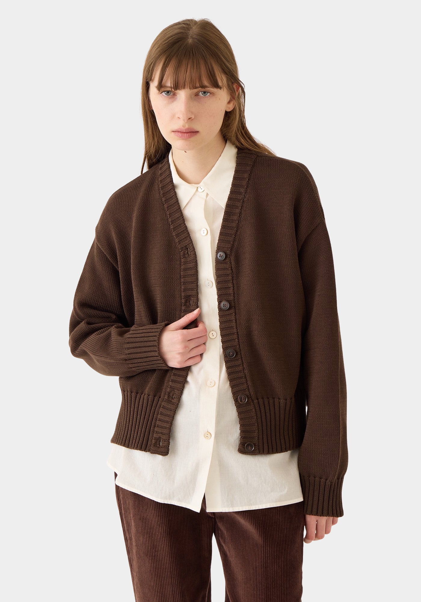 DEMYLEE Vivian Organic Cotton Cardigan Espresso styled over a cream button-down shirt
