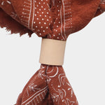 Eco Raw Studio Terracotta Classic Print Naturally Dyed Bandana in Terracotta x White Ink styled with a leather scarf ring
