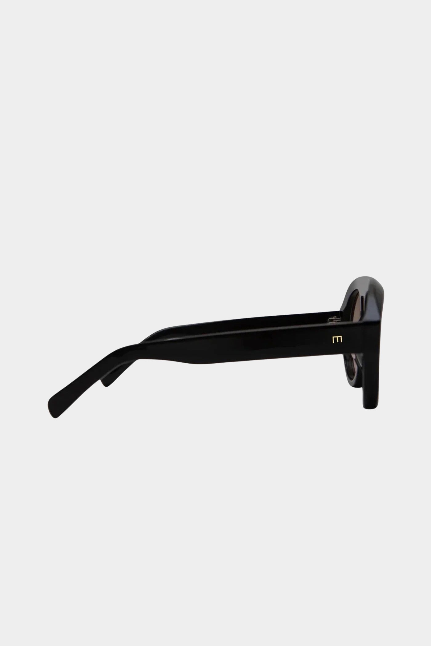 Side view of Elisa Johnson Val sunglasses showing the black acetate temple with a small gold logo.
