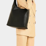 IL BISONTE black leather shoulder bag worn on shoulder on model