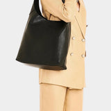 IL BISONTE black leather shoulder bag worn on shoulder on model