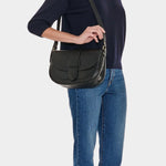 IL BISONTE black leather crossbody bag side profile worn on model