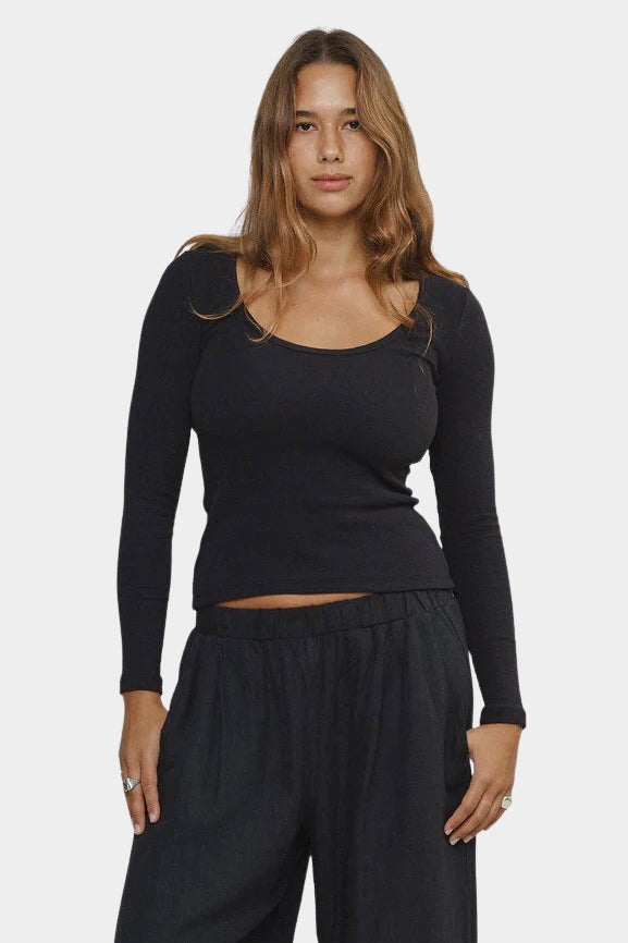 Woman wearing Jungmaven Paseo Long Sleeve Tee in Black, front detail view