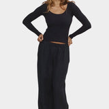Woman wearing Jungmaven Paseo Long Sleeve Tee in Black with wide leg pants
