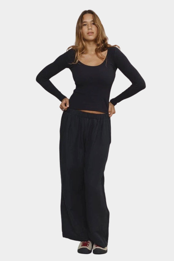 Woman wearing Jungmaven Paseo Long Sleeve Tee in Black with wide leg pants