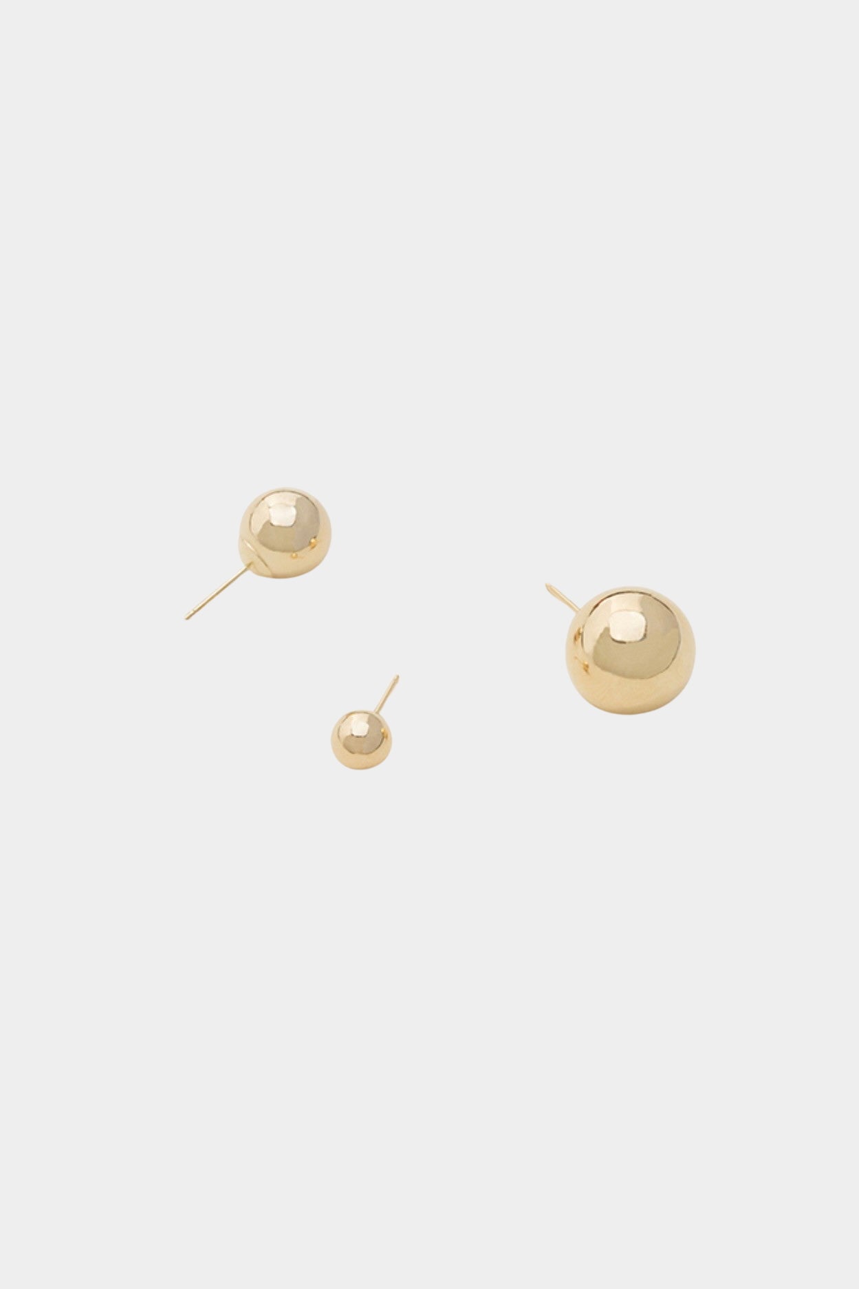 Polished gold ball stud earrings in multiple sizes with smooth high-shine finish.