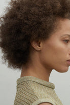 Model wearing delicate 14K gold long bar stud earring.