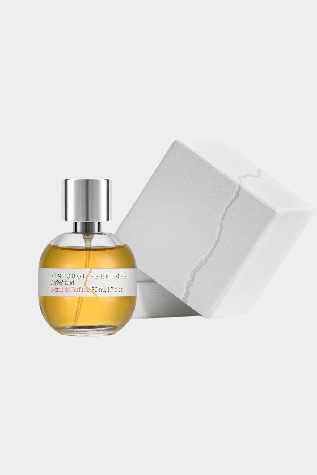 Ambré Oud perfume by Kintsugi Perfumes beside white presentation box, available at YUCCA Denver