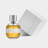 Ambré Oud perfume by Kintsugi Perfumes beside white presentation box, available at YUCCA Denver