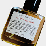 Kismet Olfactive Vetiver Supreme eau de parfum 50ml bottle with black cap, amber liquid, and white label on neutral background