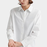 Kowtow Daily Shirt in white close up showing relaxed fit and button placket