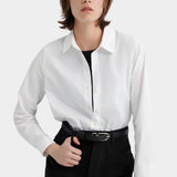 Kowtow Daily Shirt in white worn tucked into black trousers, front view