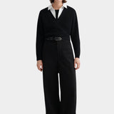 Kowtow Daily Shirt in white worn under black wrap sweater with wide leg trousers, full length view
