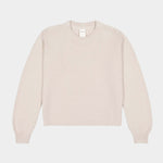 Flat lay of cream textured crewneck sweater with ribbed neckline, cuffs, and hem.