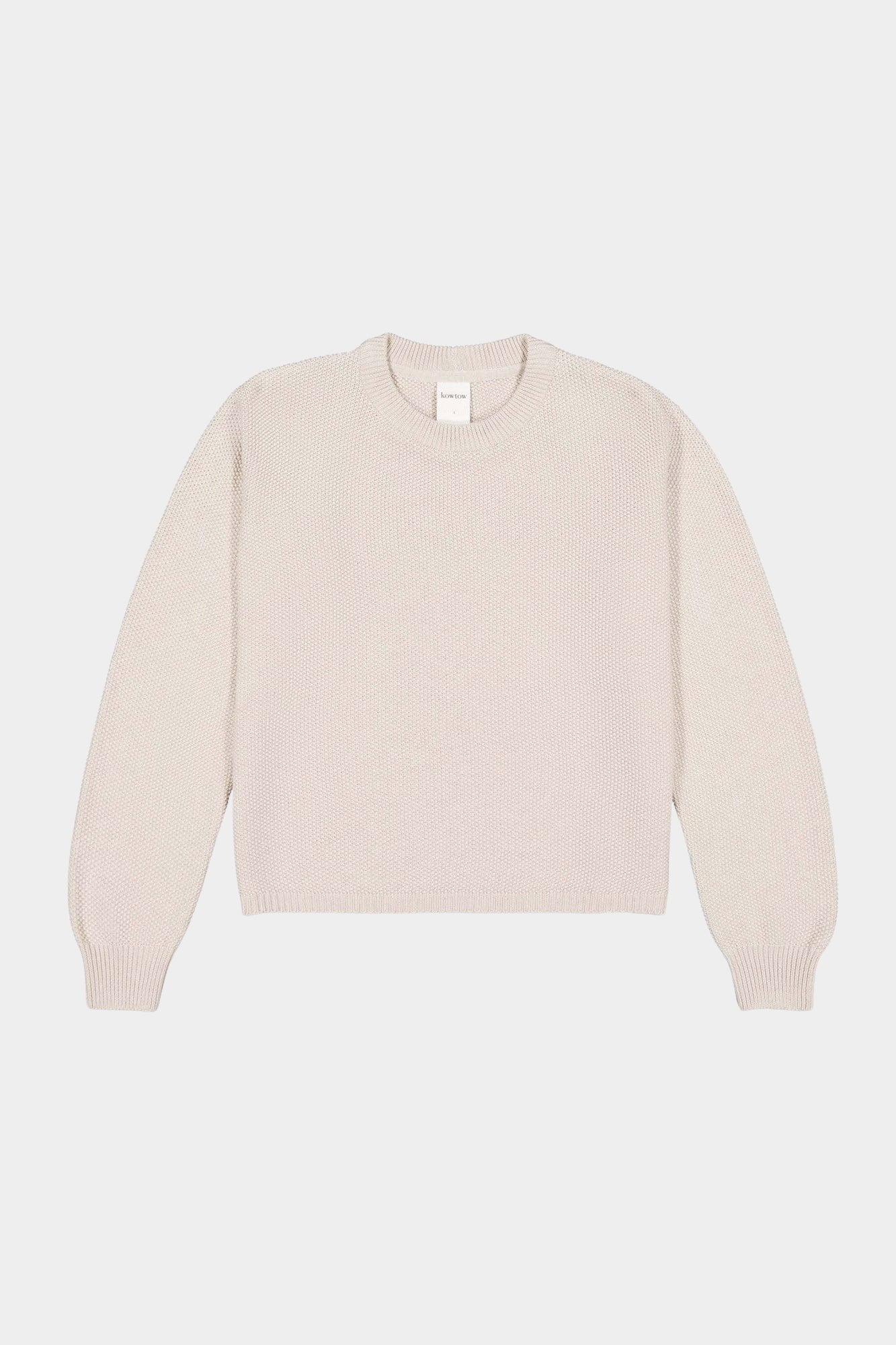 Flat lay of cream textured crewneck sweater with ribbed neckline, cuffs, and hem.